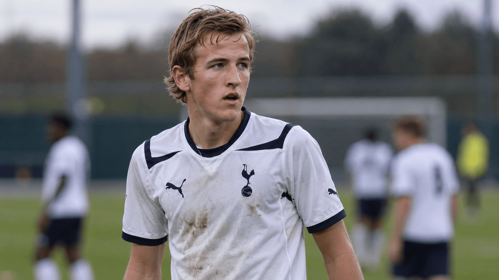 Illustration: a teenage Harry Kane in a mud-stained white Tottenham shirt on an academy pitch