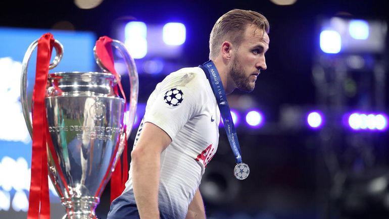 Harry Kane walks past the Champions League trophy wearing a runner-up's medal after Tottenham's defeat to Liverpool in the 2019 final