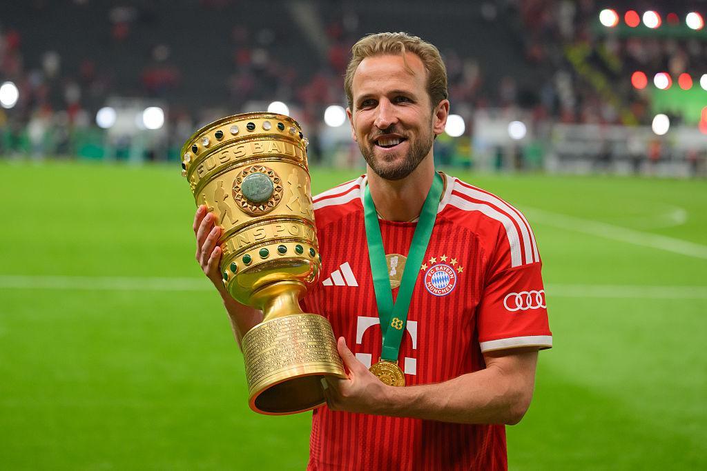 Harry Kane holds the DFB-Pokal, a winner's medal around his neck, after Bayern Munich's 3-0 final win over VfB Stuttgart in 2026