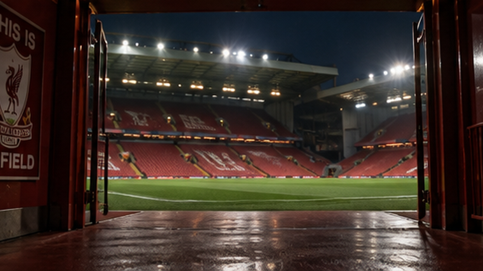 The players' tunnel at Anfield opens onto the pitch and floodlit stands at night, the "This Is Anfield" sign on the wall to the left